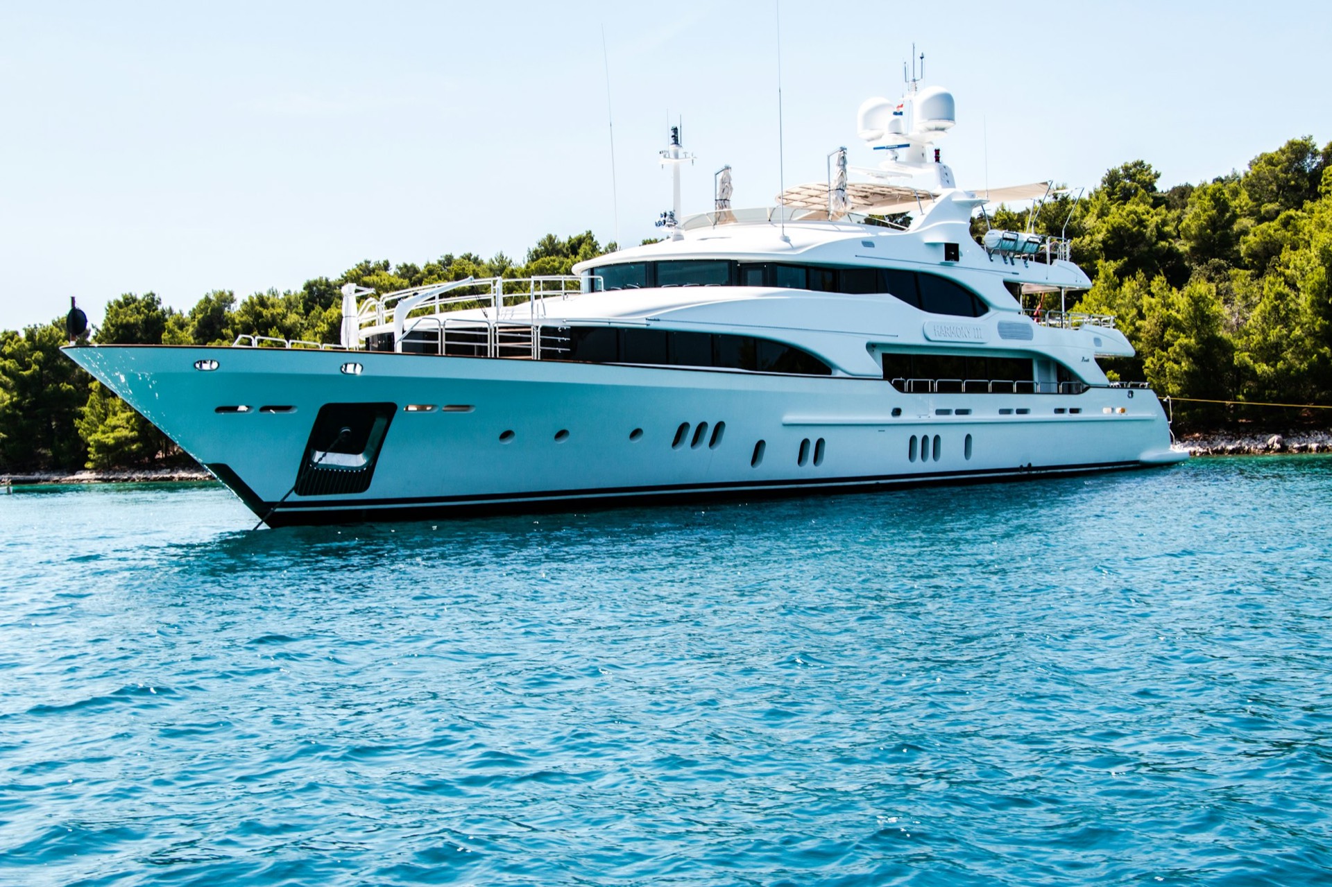 Superyacht salon with expansive glazing at sunset